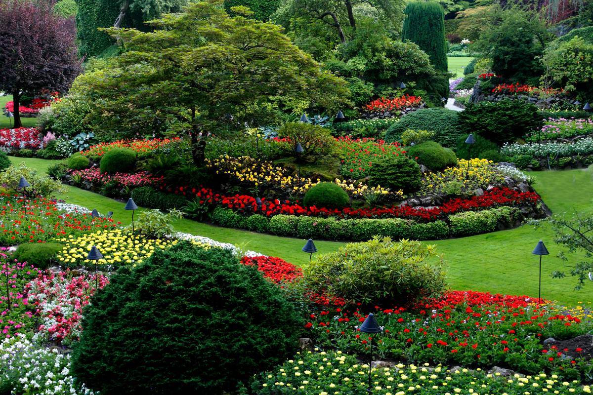 Modern black garden statues outdoor decor arranged beside a stone pathway with uplighting