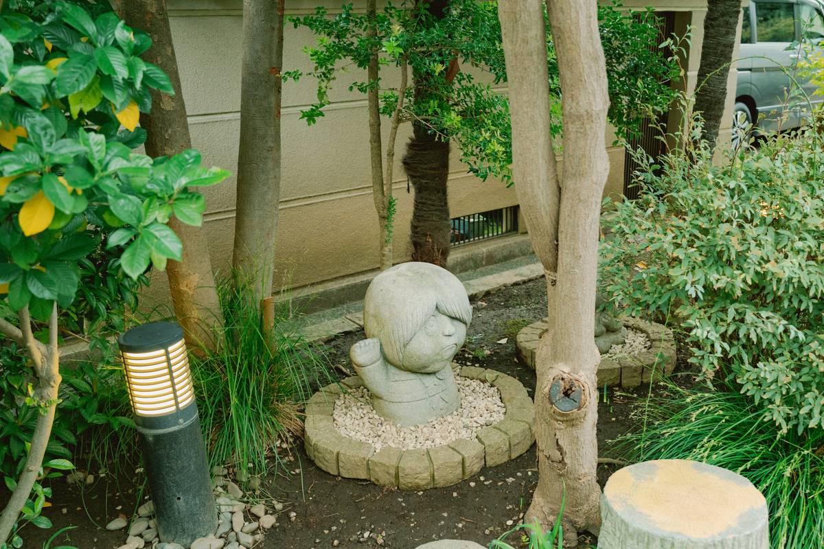 lawn art accent garden ornament how displayed among flowering shrubs with proper spacing and anchoring