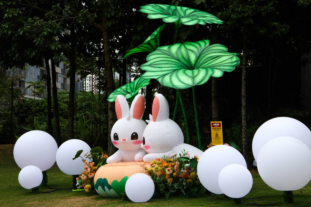 White resin bunny garden statue outdoor decor nestled among lavender and hydrangeas