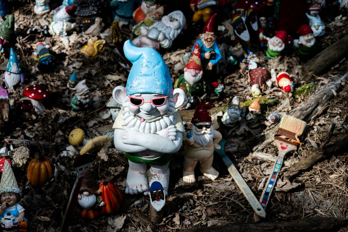 garden ornaments ideas featuring stone statues, ceramic frogs, and metal wind spinners arranged in a lush backyard